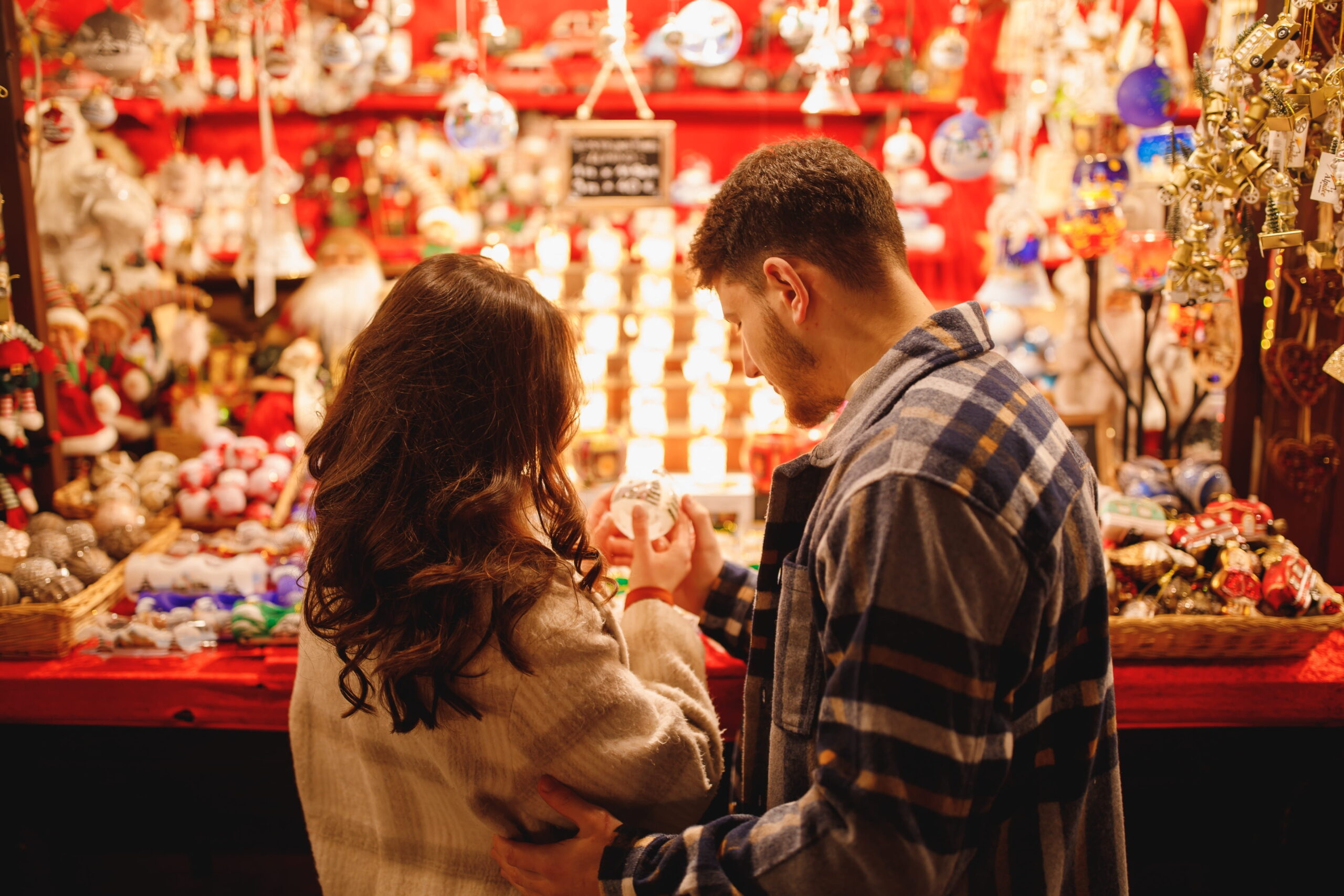 response-marketing-group-rmg-discover-dahlonega-georgia-christmas-market-Young-stylish-couple-in-checkered-coats-choosing-the-Christmas-toys
